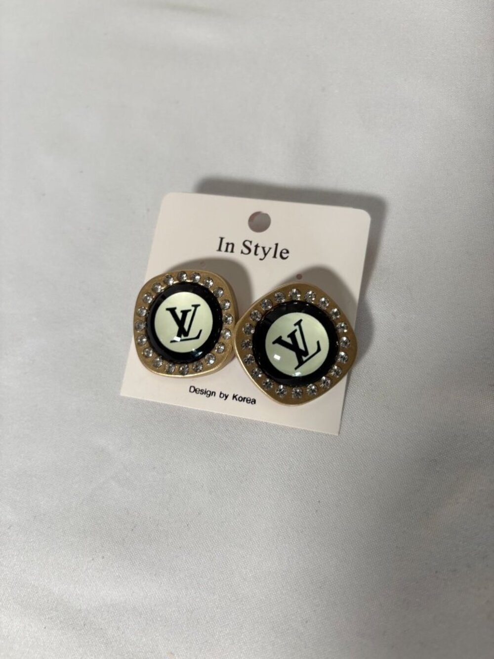 Designer-inspired rhinestone logo stud earrings in gold/black
